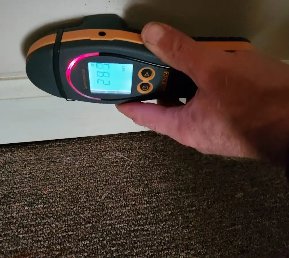 Moisture detection at baseboard during Storm Damage Restoration in Manville